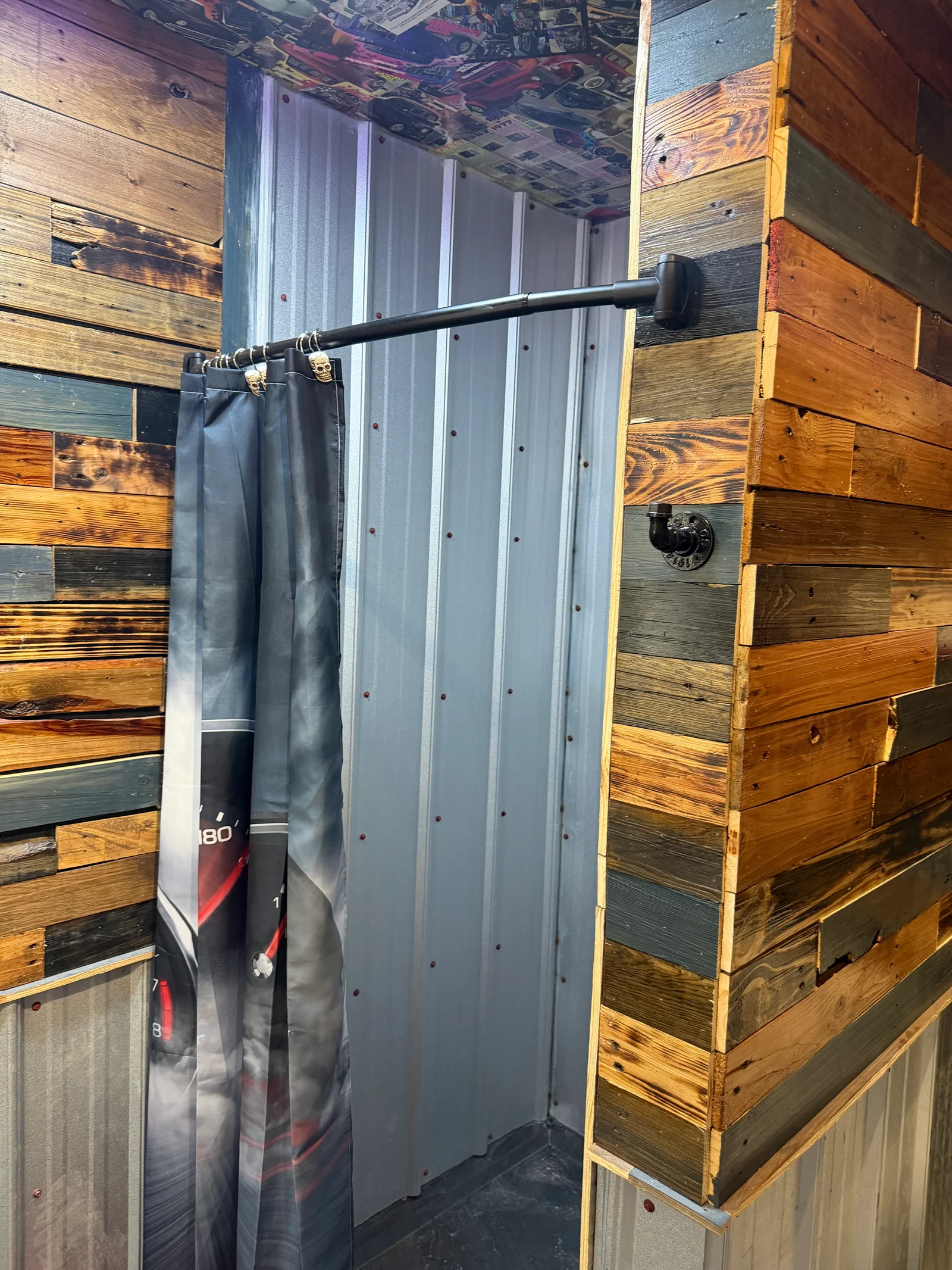 Reclaimed wood accent wall with mixed stains and corrugated metal backing