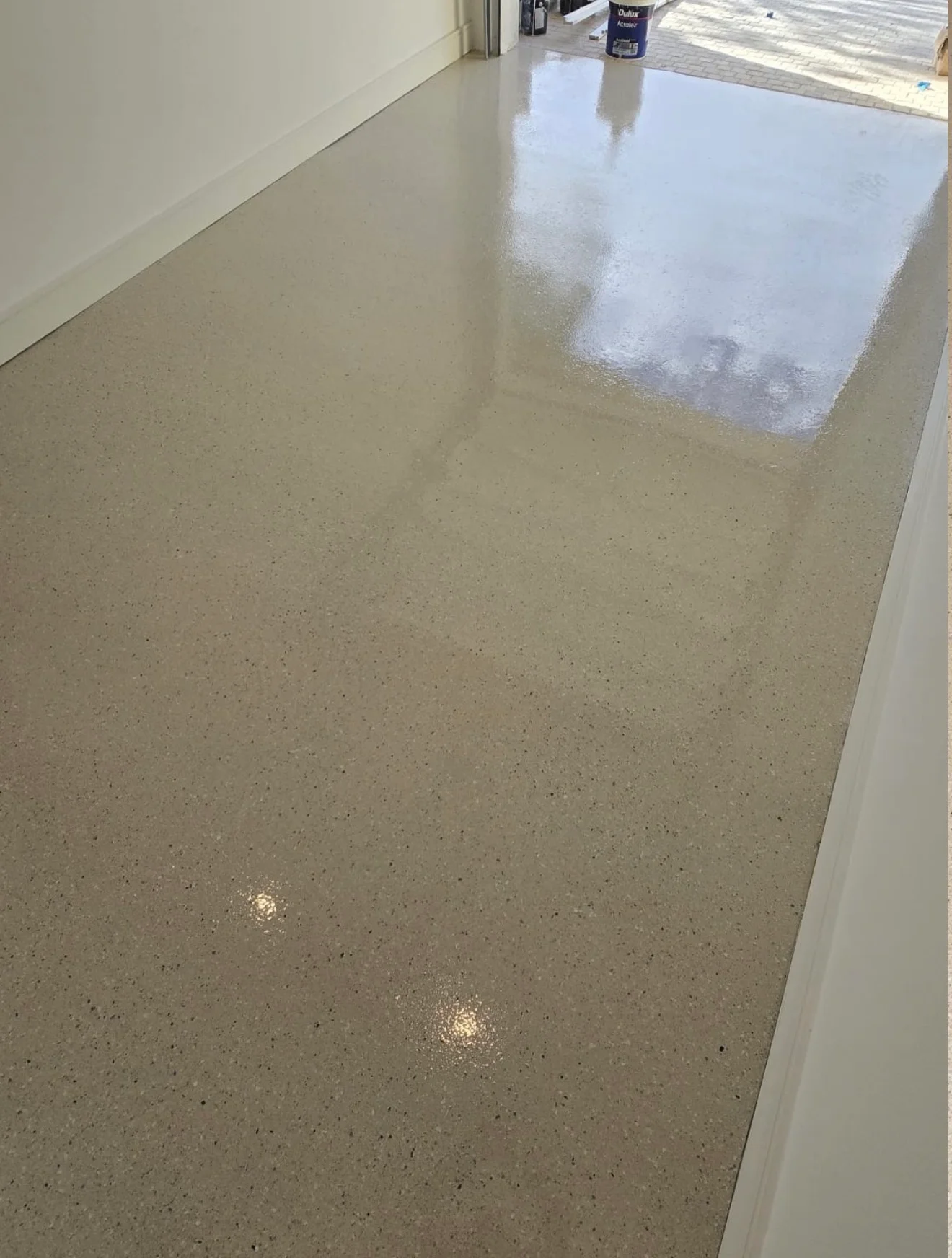 Polished concrete floor with glossy protective coating and aggregate finish
