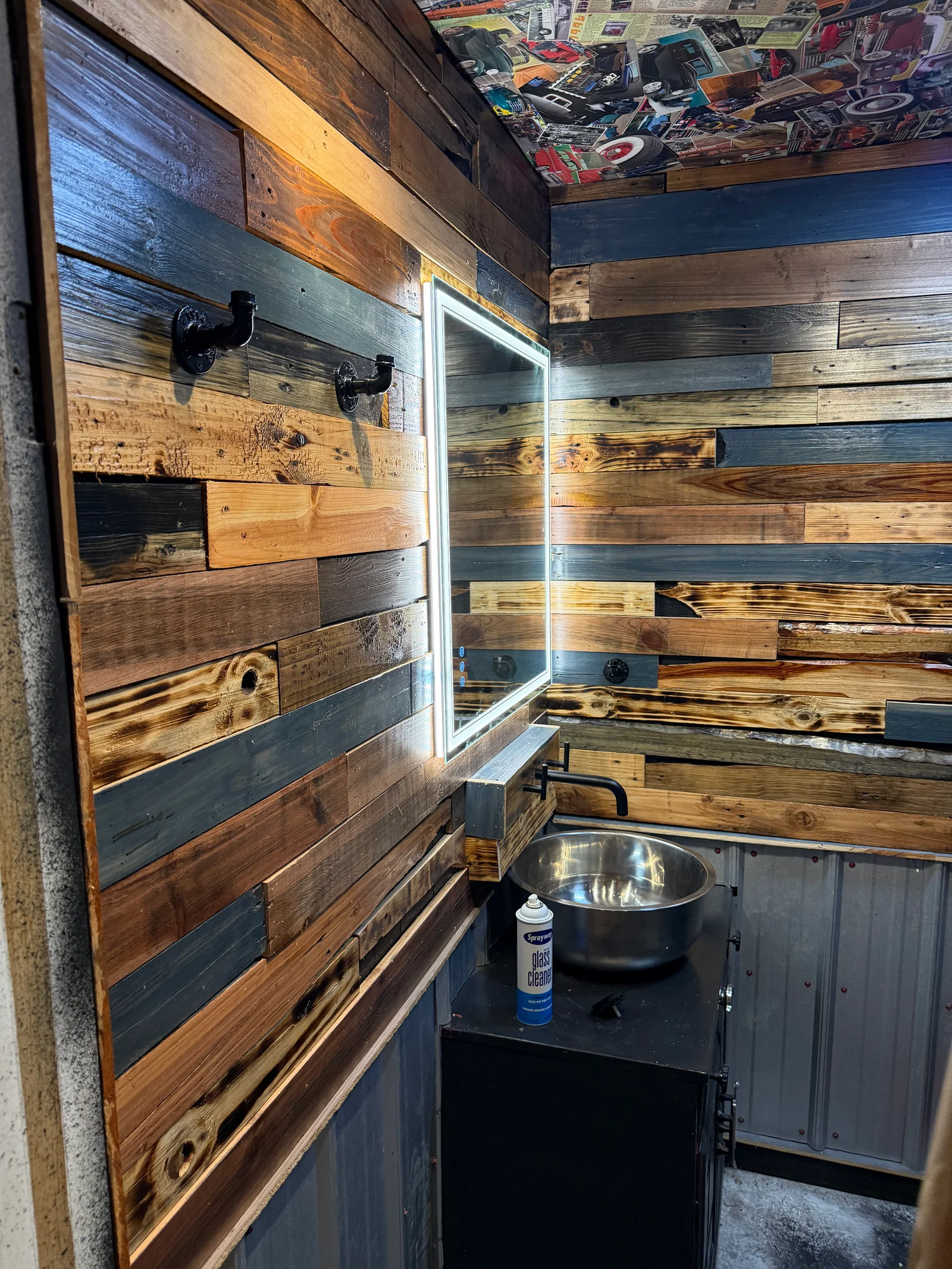 Shiplap wall with mixed wood stain colors and LED-lit mirror frame in bathroom