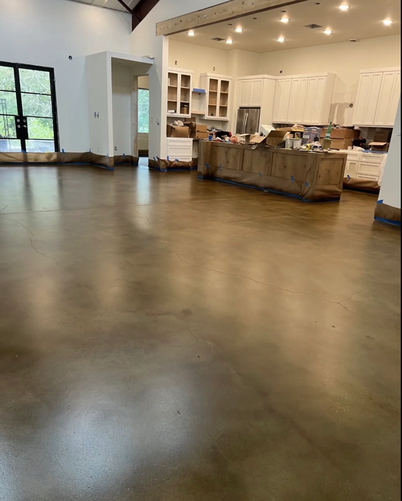 Polished concrete floor coating in open kitchen and living space with white cabinetry